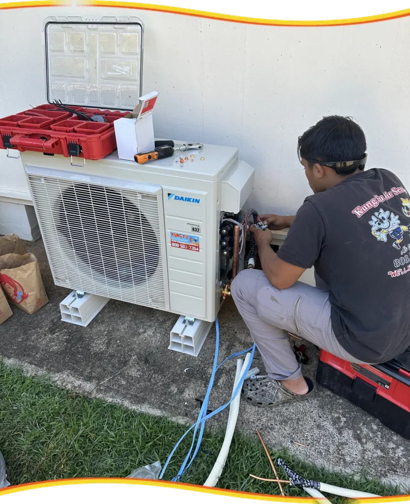 Kung Fu Air Service technician servicing a Daikin outdoor AC condenser on Oahu