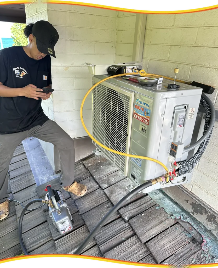 Kung Fu Air Service technician servicing an outdoor AC condenser unit