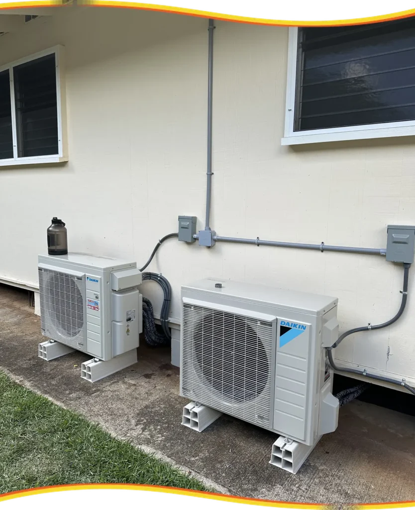 Two Kung Fu Air Service outdoor mini-split condenser units