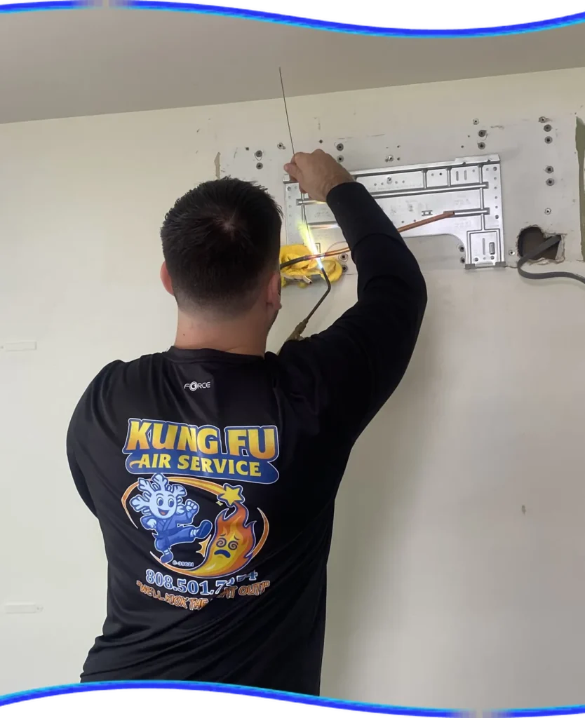 Kung Fu Air Service technician working on an indoor wall-mounted AC unit